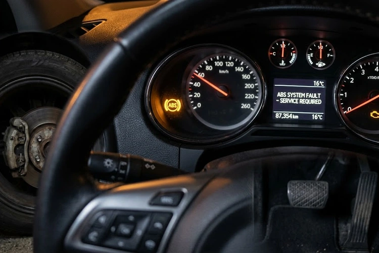 ABS warning light illuminated on car dashboard indicating ABS not working symptoms