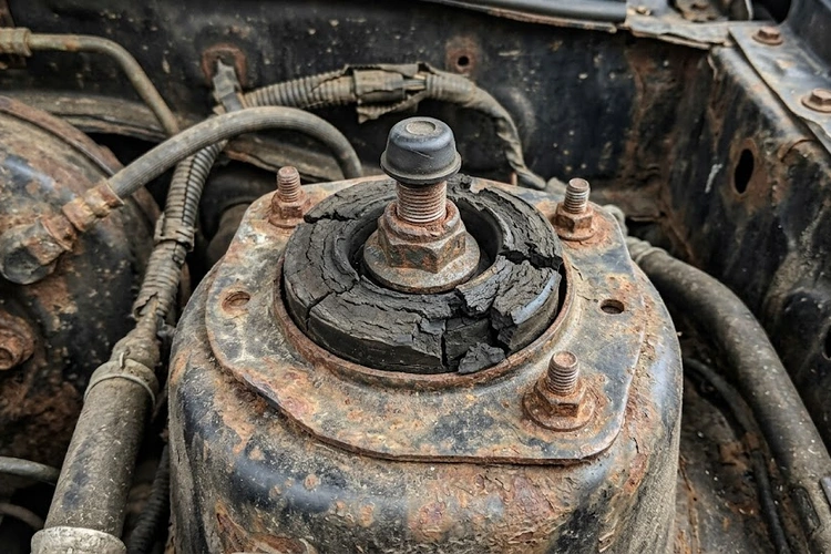 Car shakes at low speed — mechanic inspecting front suspension, wheel hub, and tire assembly