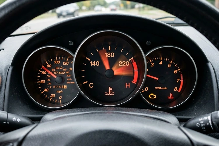 Temperature gauge fluctuating on a car dashboard showing erratic needle movement