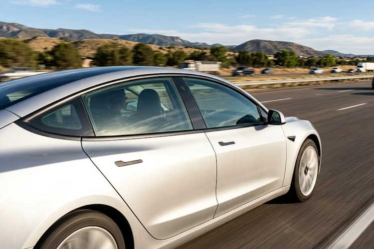 mechanic inspecting car door seal to diagnose whistling noise while driving