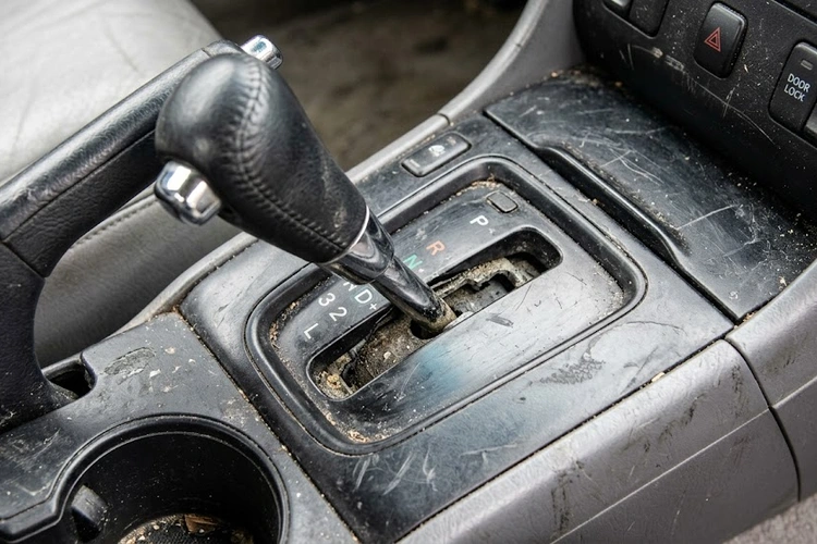 Close-up of a loose wobbly gear shifter showing visible play and worn shifter base components