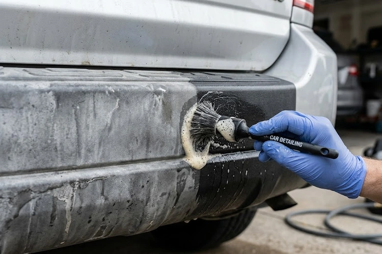 Cleaning exterior car plastic trim with a detailing brush and all-purpose cleaner