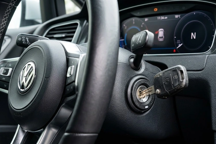 Close-up of a car key stuck in an ignition cylinder