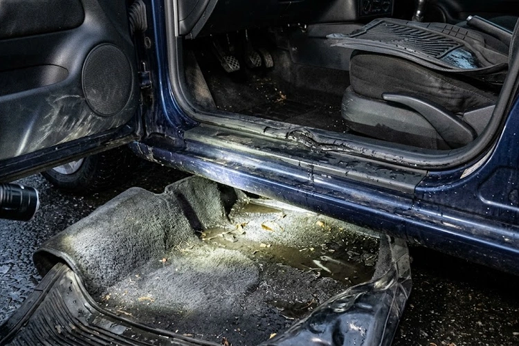 water leaking into car floor — wet carpet on passenger side floor mat
