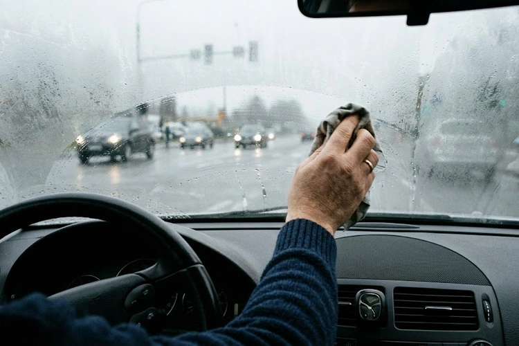 windshield fogging up inside a car on a cold, damp morning