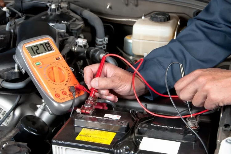 Digital multimeter being used on a car battery
